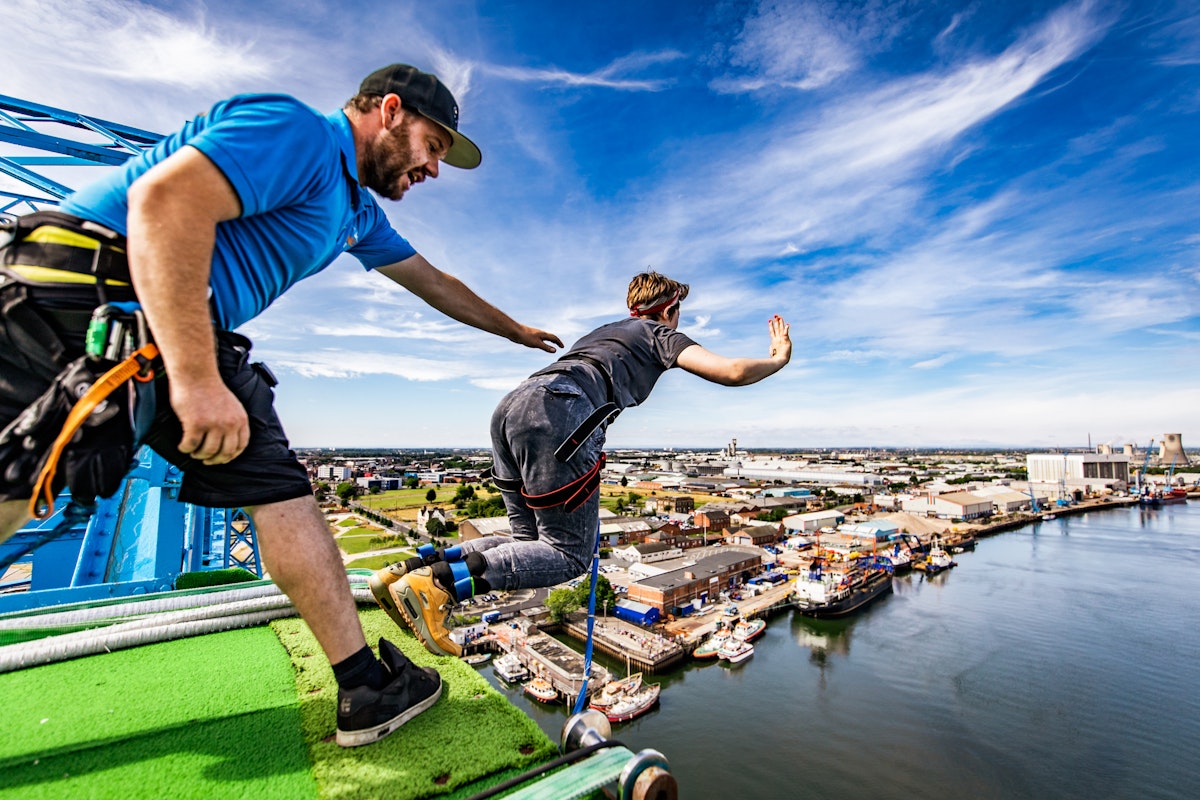 A man bungee jumping off a building